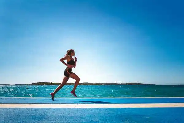 Woman running showing strong leg muscle Alcester